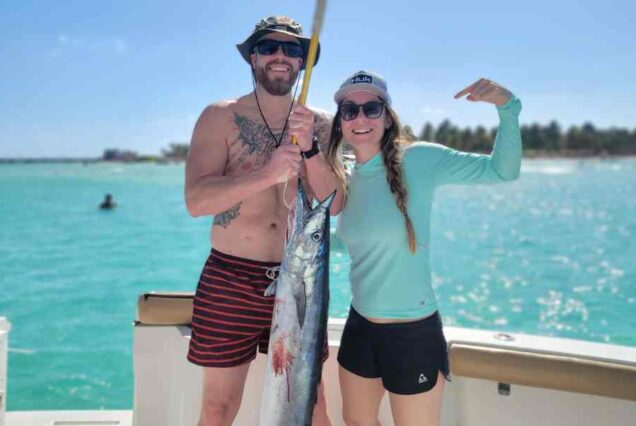 man and woman holding fish caught on 6 hr deep sea fishing charter