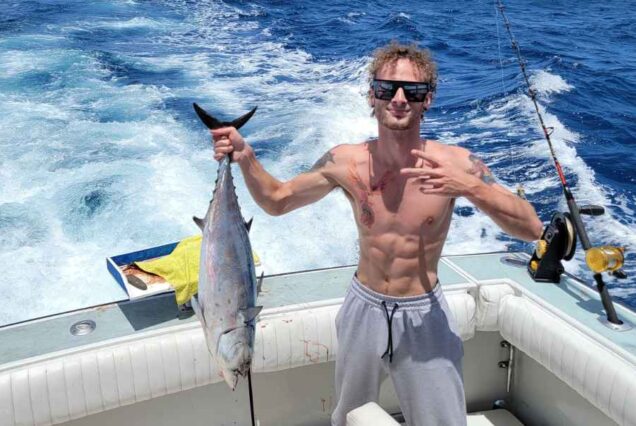 man holding tuna fish caught on 4 hr deep sea fishing charter in cancun mexico
