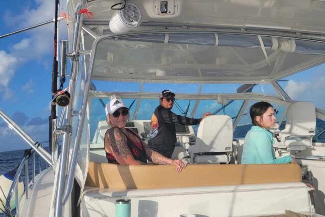 group on board a private fishing charter and beach tour excursion while in Cancun