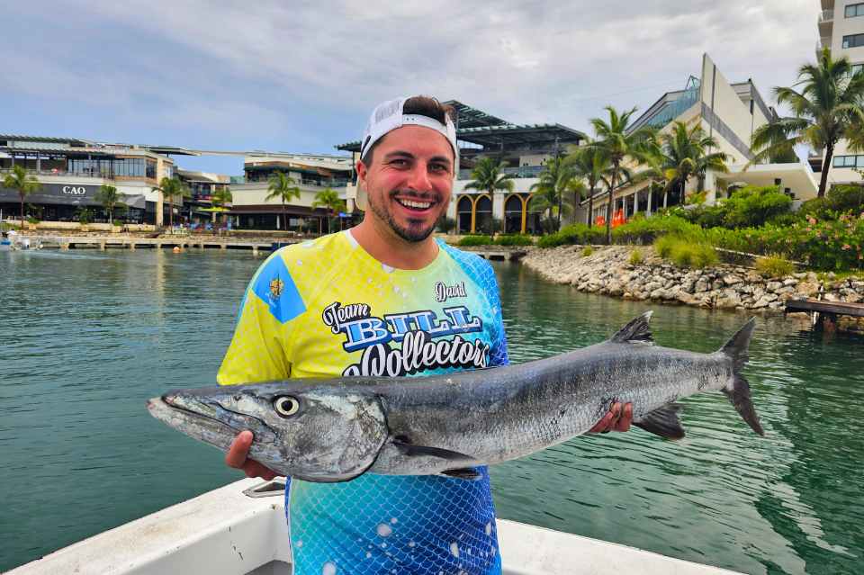 man holding fish caught after reading deep sea fishing in cancun first time guide