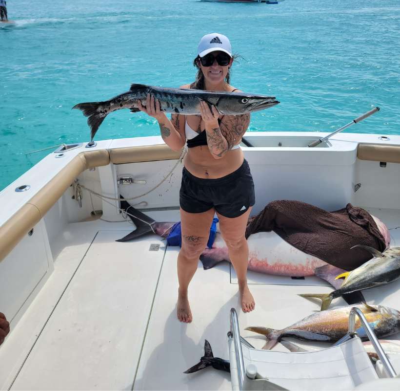 woman holding fish after being on best fishing charters in quintana roo cancun