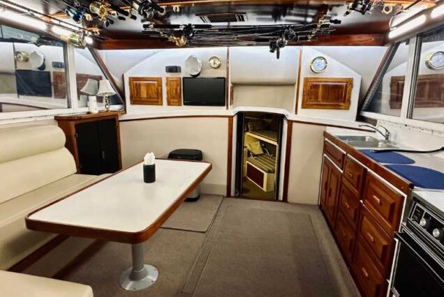 inside 6 Hr Deep Sea Fishing Charter boat showing seating area and full kitchen