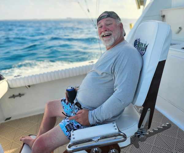 man sitting in cancun charter fishing boat fighting chair