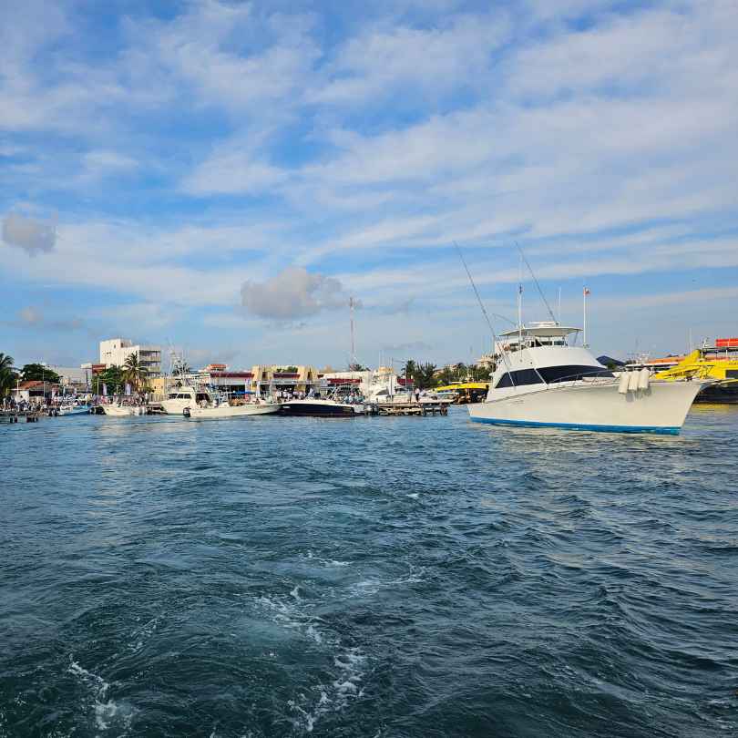 view of isla mujeres marina from ocean while on boat during the day