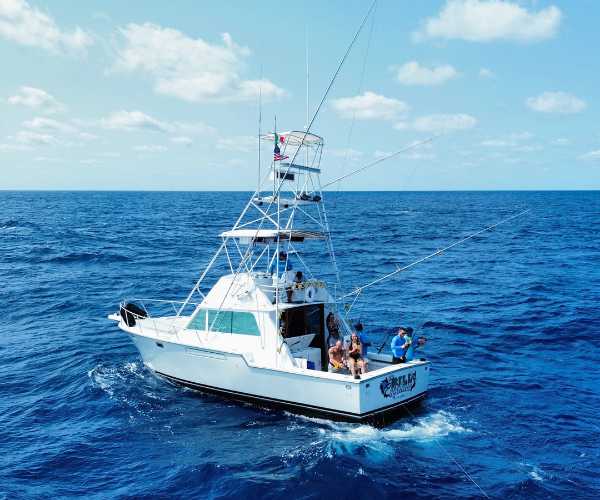 cancun fishing charter boat in deep ocean in cancun