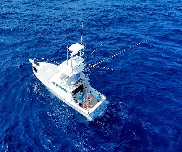 aerial photo of blue ocean and cancun fishing charter boat