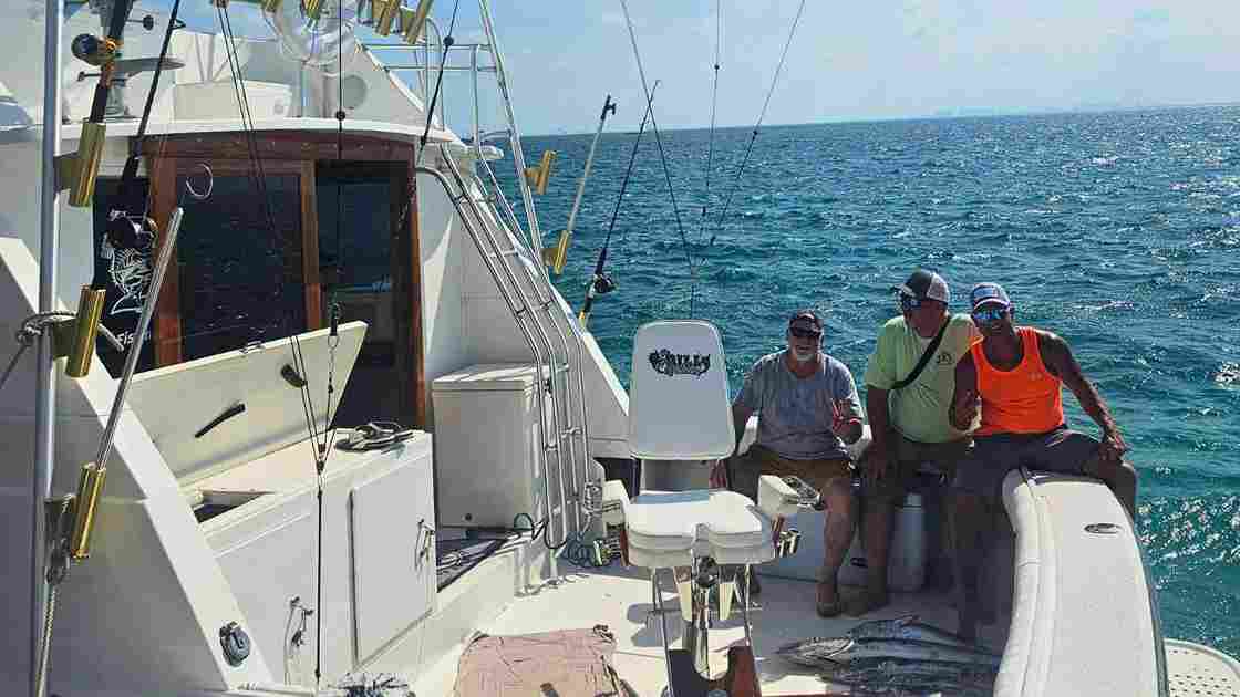 three men in boat on fishing trip in Cancun